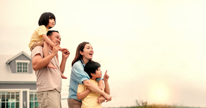 Happy Parents With Their Children. Portrait Of A Cheerful Family. Happy Asian Family. Beautiful Family Portrait Smiling Outside Their New House..