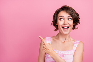 Photo of young cheerful lady wondered look indicate finger empty space promotion advert advise...