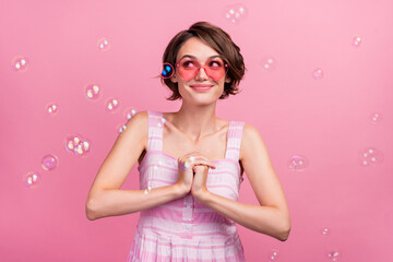 Obraz na płótnie Canvas Photo of young attractive girl admire fly bubbles soap foam sunglass wondered look empty space isolated over pink color background