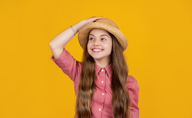 happy kid in straw hat on yellow background