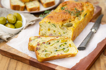 French savoury cake with olives, zucchini, ham and cheese - 508227395