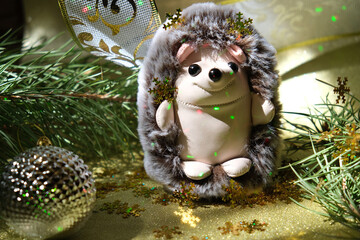 Festive still life with fluffy funny toy hedgehog and Christmas decorations. New Year card. Nersery bedroom decor