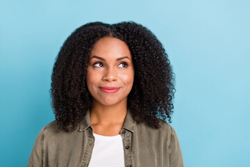 Photo of pretty positive satisfied lady look interested empty space isolated on blue color background