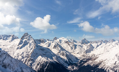 Fototapeta na wymiar Panorama of winter snowy mountains in Caucasus region, Russia