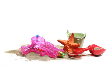 Toys on pile sand isolated on white  