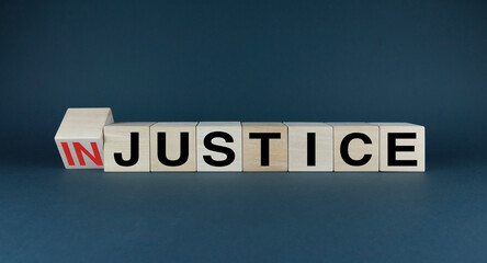 Injustice or justice. Cubes form the choice words Injustice or Justice.