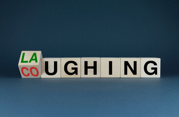 Laughing or Coughing. The dice form the choice words Laughing or Coughing.