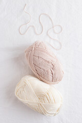 Balls of cotton yarn pastel colors on a white table