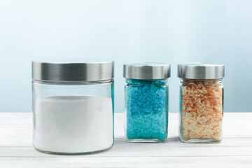 A bottle of aromatic oil and jars of aromatic spa salt