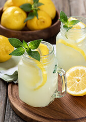 Two glasses of lemonade with mint and lemons