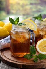 Glass of ice tea with lemon and mint