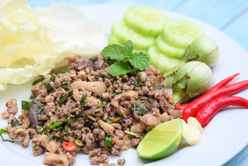cooking duck , spicy minced duck salad with herb spices fresh vegetable eggplant cucumber chinese cabbage garlic chili lime and mint leaf - Asian Thai Food