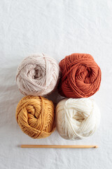 Balls of cotton yarn warm colors on a white table