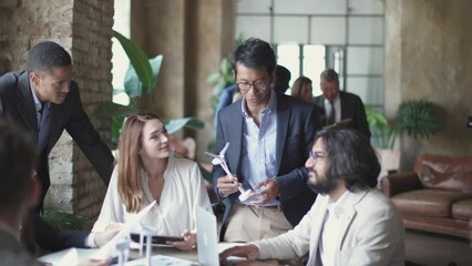 group of multiethnic colleagues at office speaking about energy wind strategy - Powered by Adobe