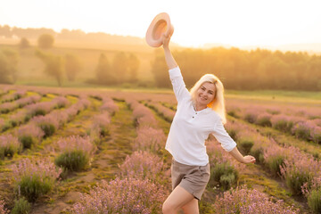 Fototapeta premium A Woman Walking in Lavender Field