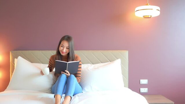 Beautiful Woman Reading Romantic Novel Book in Bedroom, Static View