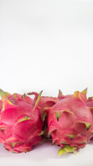 RED PITAHAYA DRAGÓN FRUIT ON A WHITE BACKGROUND WITH SPACE FOR TEXT, HEALTHY DIET WITH EXOTIC TROPICAL FRUITS