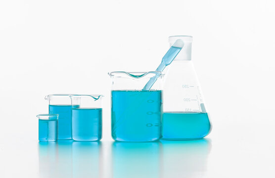 Set of chemical flasks with blue substance in lab