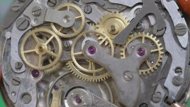 Analog clock mechanism gears moving, macro close-up fast stop motion timelapse