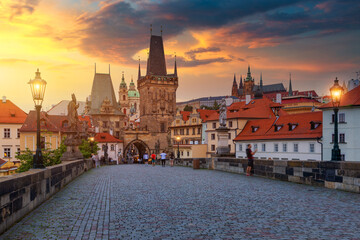 Fototapeta premium Charles Bridge in Prague at sunset. Prague, Czech Republic. Charles Bridge (Karluv Most) and Old Town Tower. Vltava River and Charles Bridge. Concept of world travel, sightseeing and tourism.