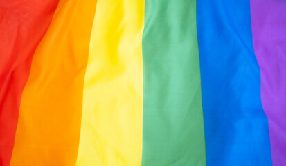 Rainbow flag as a background.LGBT,LGBTQ,LGBTQ+ concept.Homosextual and gender quality symbol.Soft Velvet Piece of Fabric with Folds in rainbow color to be used as background or overlay.