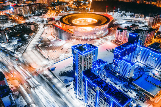 Aerial view of stadium with night illumination and residential buildings in the center of Yekaterinburg. Russia