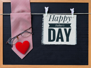 Happy Father's day sign with red necktie and eyeglasses and red heart on black background, father's day card background concept