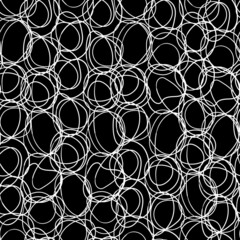 Endless pattern of hand drawn doodles of rings, springs, circles.
