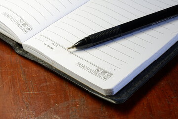 a pen on a book taken from a high angle