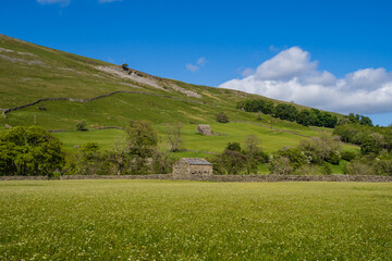 On the Coast to Coast long distance footpath walk at Muker in Swaledale in the Yorkshire Dales