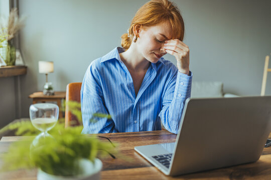 Frustrated sad woman feeling tired worried about problem sitting on sofa with laptop, stressed depressed girl troubled with reading bad news online