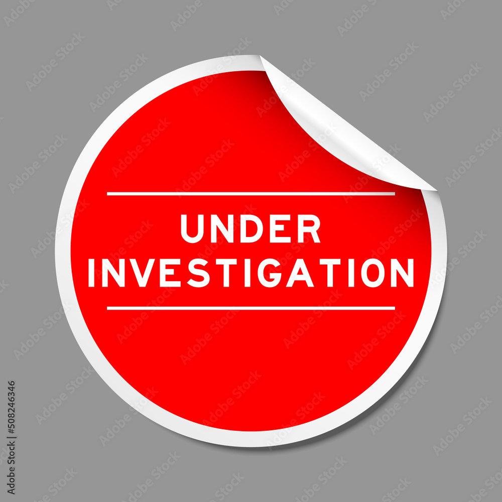 Wall mural Red color peel sticker label with word under investigation on gray background