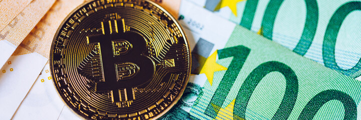 Golden bitcoin over Euro money. Bitcoin cryptocurrency. Crypto currency concept. Bitcoin with euro bills. Bitcoins stacked on euro banknotes.