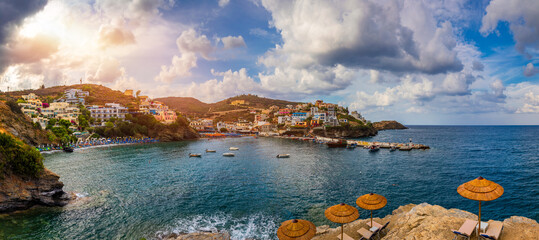 Panorama of Harbour with vessels, boats, beach and lighthouse in Bali at sunrise, Rethymno, Crete, Greece. Famous summer resort in Bali village, near Rethimno, Crete, Greece. - 508248180