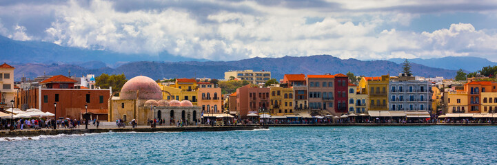 Obraz premium Mosque in the old Venetian harbor of Chania town on Crete island, Greece. Old mosque in Chania. Janissaries or Kioutsouk Hassan Mosque in Chania Crete. Turkish mosque in Chania bay. Crete, Greece.