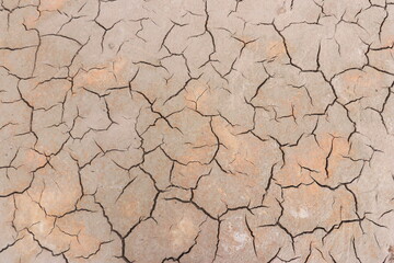 Top view of the dried up cracked soil. Drought, crop failure, global warming, climate change concept. Abstract texture background