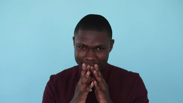 Tricky man. Evil plan. Prank scheme. Boomerang animation. Devious sneaky sly black Afro guy steepling fingers isolated on blue background GIF loop motion.