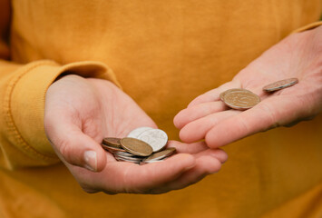 Concept of poor human. Russian coins hold in hands and count. Crisis and economic downturn. Russian...