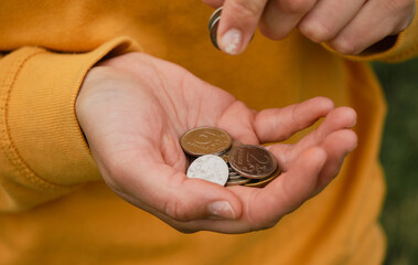 Concept of poor human. Russian coins hold in hands and count. Crisis and economic downturn. Russian...