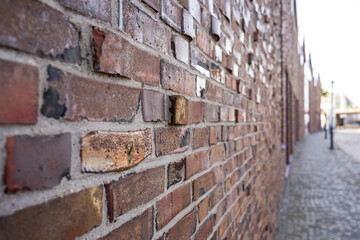 Brick wall of an ancient building on the street of a cozy provincial town. 