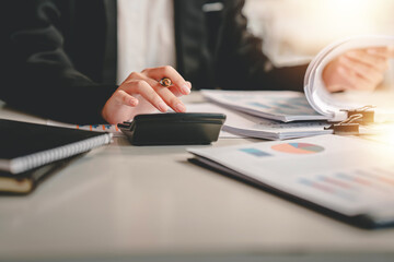business woman or accountant who are using a calculator to calculate business data Accounting...