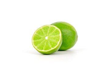 Fresh and ripe green lime whole and cut in half, vitamin rich fruit, exotic fruit isolated