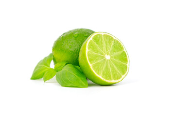 Fresh and ripe green lime whole and cut in half, vitamin rich fruit, exotic fruit isolated