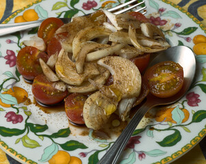 Vegan dish. Salad with onion, cherry tomatoes, Modena vinegar and Spanish oil