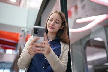 Young attractive female using a mobile phone for social media and using new online 5G technology app