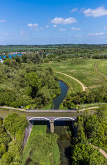 An aerial view of the Iron Trunk aqueduct and the Grand Union canal down the river Great Ouse at Wolverton, UK in summertime - obrazy, fototapety, plakaty