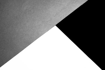 Black white and grey papers forming triangle shape textured background