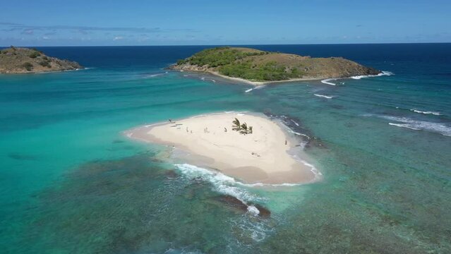 Aerial: Sandy Spit - British Virgin Islands - Orbiting shot revealing surrounding area and yachts.