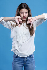 Angry teenage girl pointing her thumbs down, ready to fight - 508258136