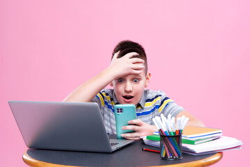 Young teenage boy attending an online class or working on his homework